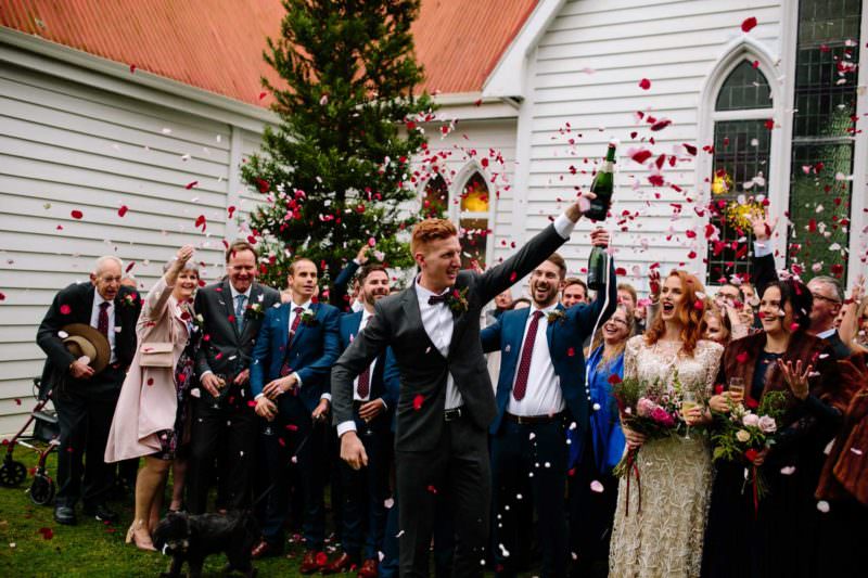 pukekohe wedding photography photo of groom popping champagne