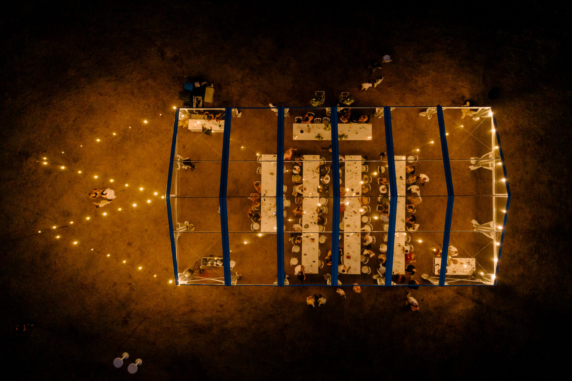 twelve tables clear marquee with festoons at night